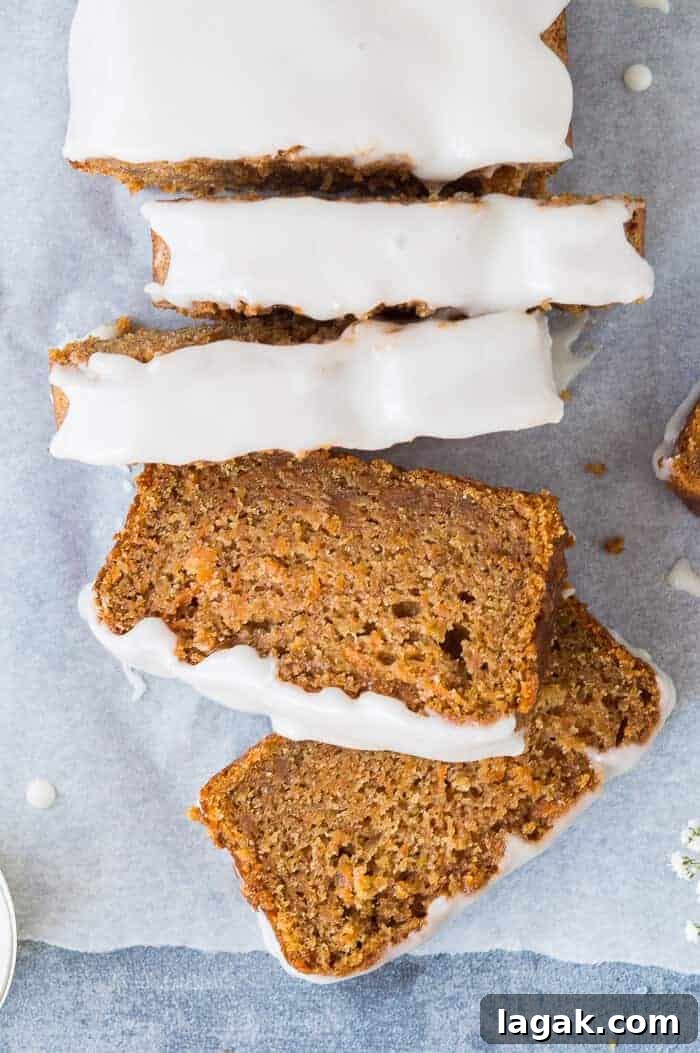 Moist Vegan Carrot Cake Loaf Recipe for Every Occasion 10 Close up of sliced vegan carrot cake loaf with lemon glaze.