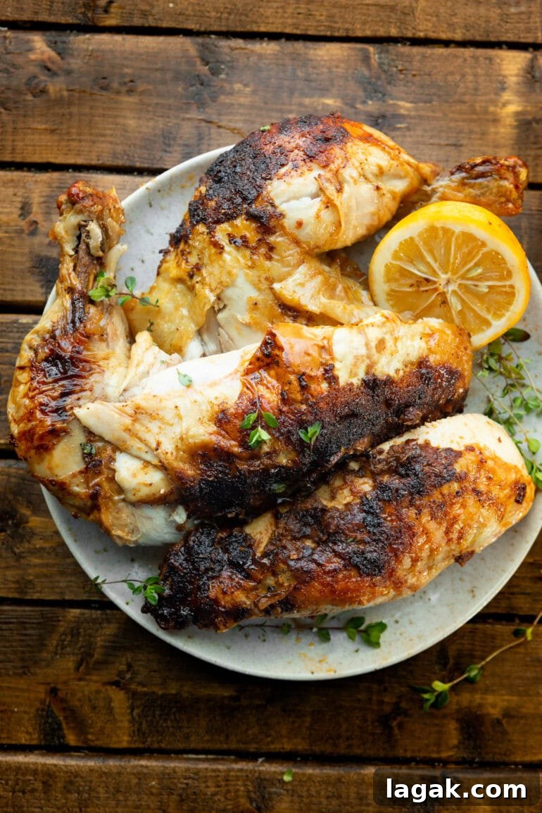 Crispy Air Fryer Whole Chicken Recipe (+ Step-by-Step Video) 4 air fried whole chicken broken into parts next to lemon