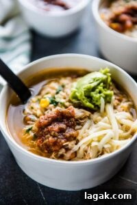 chipotle chicken burrito bowl soup in white bowls with a bowl of salsa
