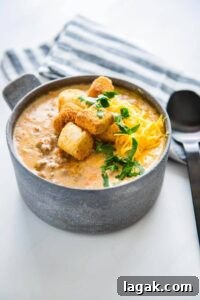 Slow Cooker Cheeseburger Soup in a metal bowl topped with croutons