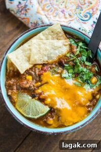 Slow Cooker Taco Soup is a family favorite dinner that has just a few ingredients and can be made in minutes. My secret ingredients makes it the best taco soup out there for flavor and richness!