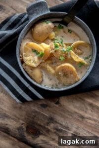 Slow Cooker Skinny Potato Soup in metal bowl with black napkin