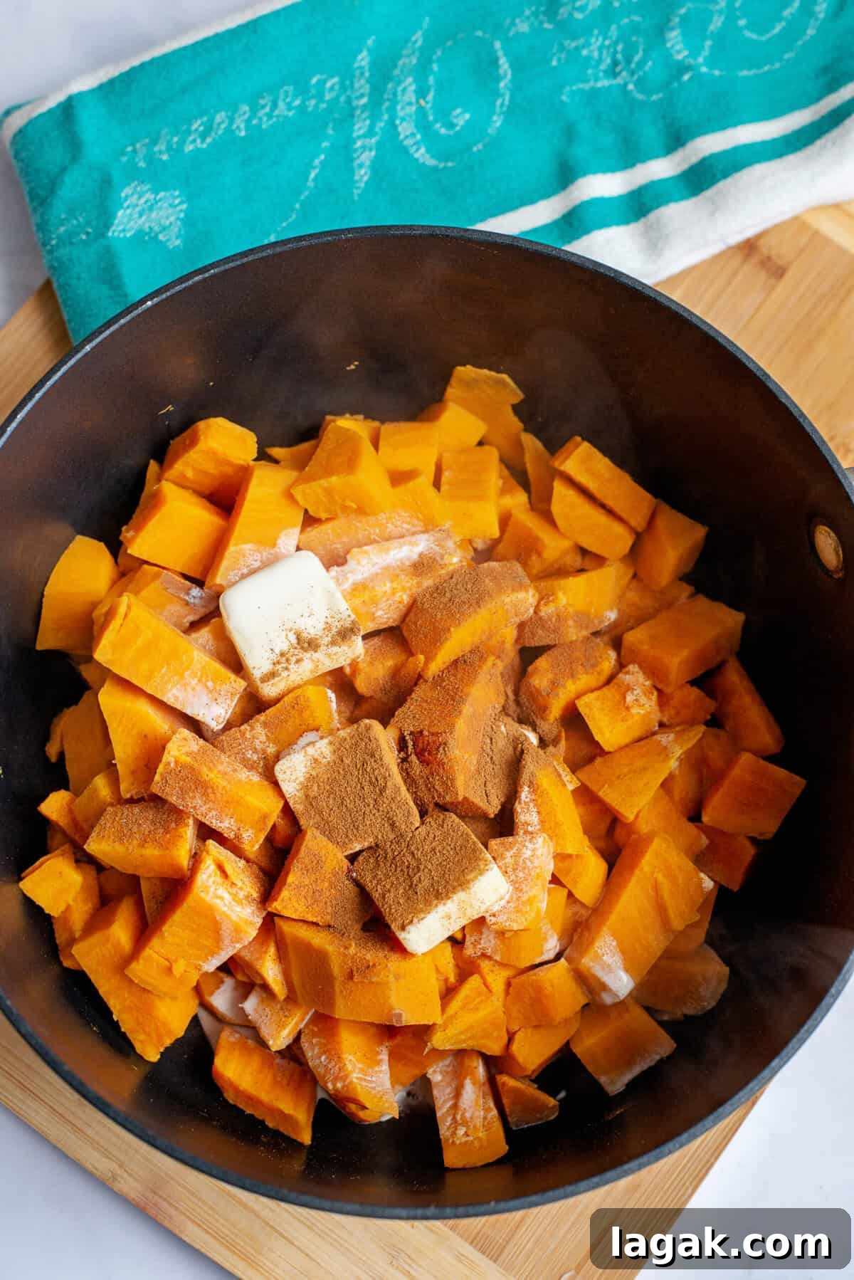 Mississippi Chicken Served Over Creamy Mashed Sweet Potatoes 12 Cooked sweet potato chunks in a pot topped with butter, cinnamon, and cream, ready to be mashed into a flavorful side dish for Mississippi chicken.