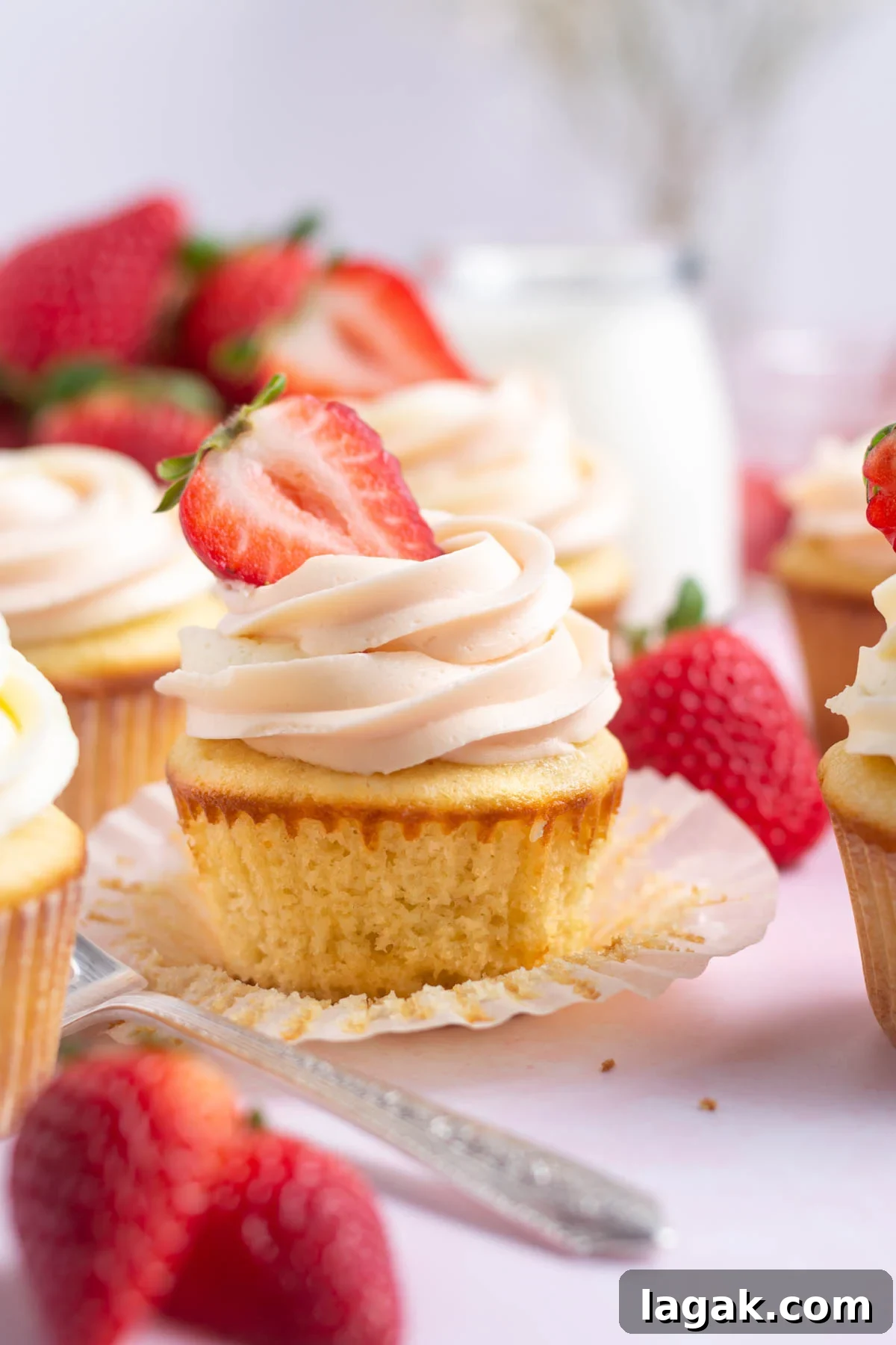 Strawberry filled cupcakes with fresh strawberries.