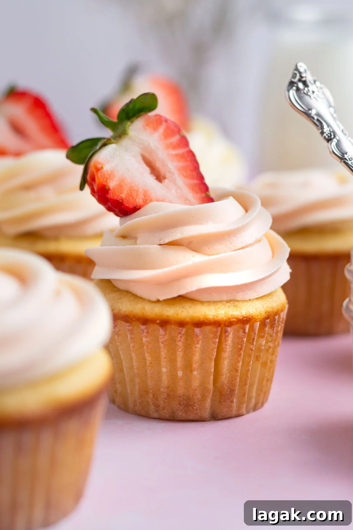 Cupcakes with buttercream and fresh strawberries.