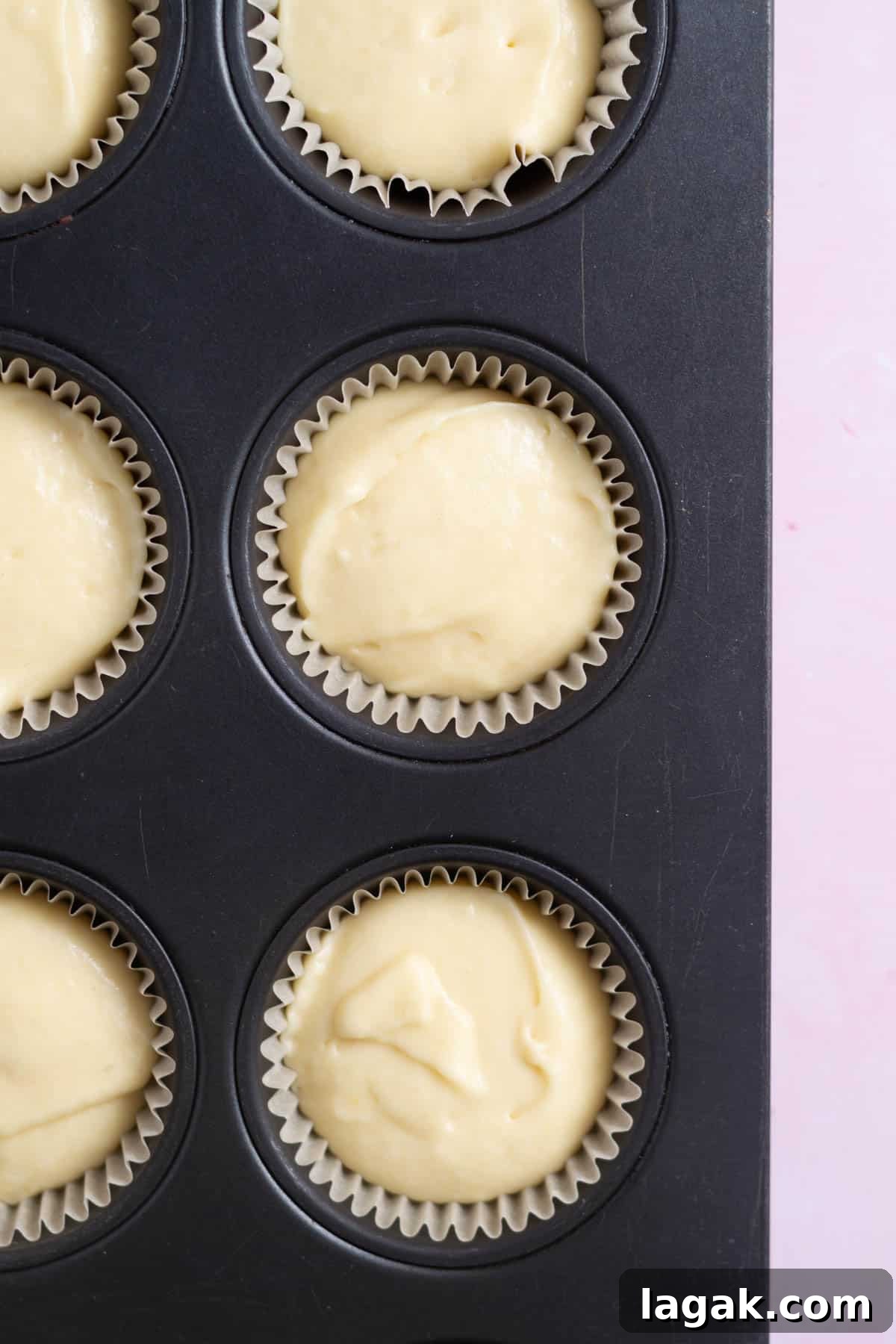 vanilla cupcake batter in cupcake liners