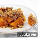 white plate and fork of Slow Cooker Sweet Potato Casserole