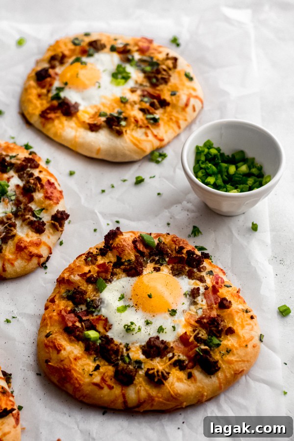 Breakfast pizzas on a white surface. Breakfast pizzas on a white surface.