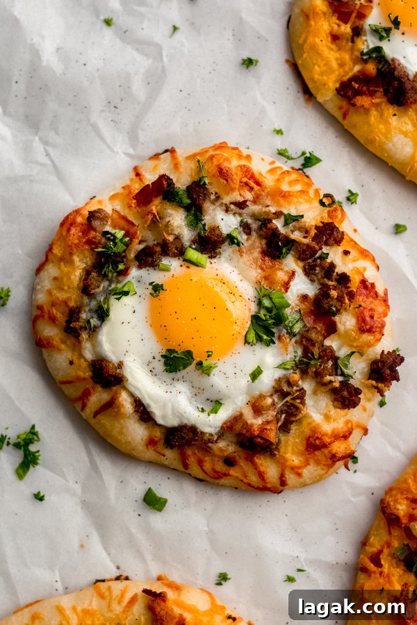 Close-up of breakfast pizza with over-easy egg. A close-up of one of the breakfast pizzas topped with an over easy egg.
