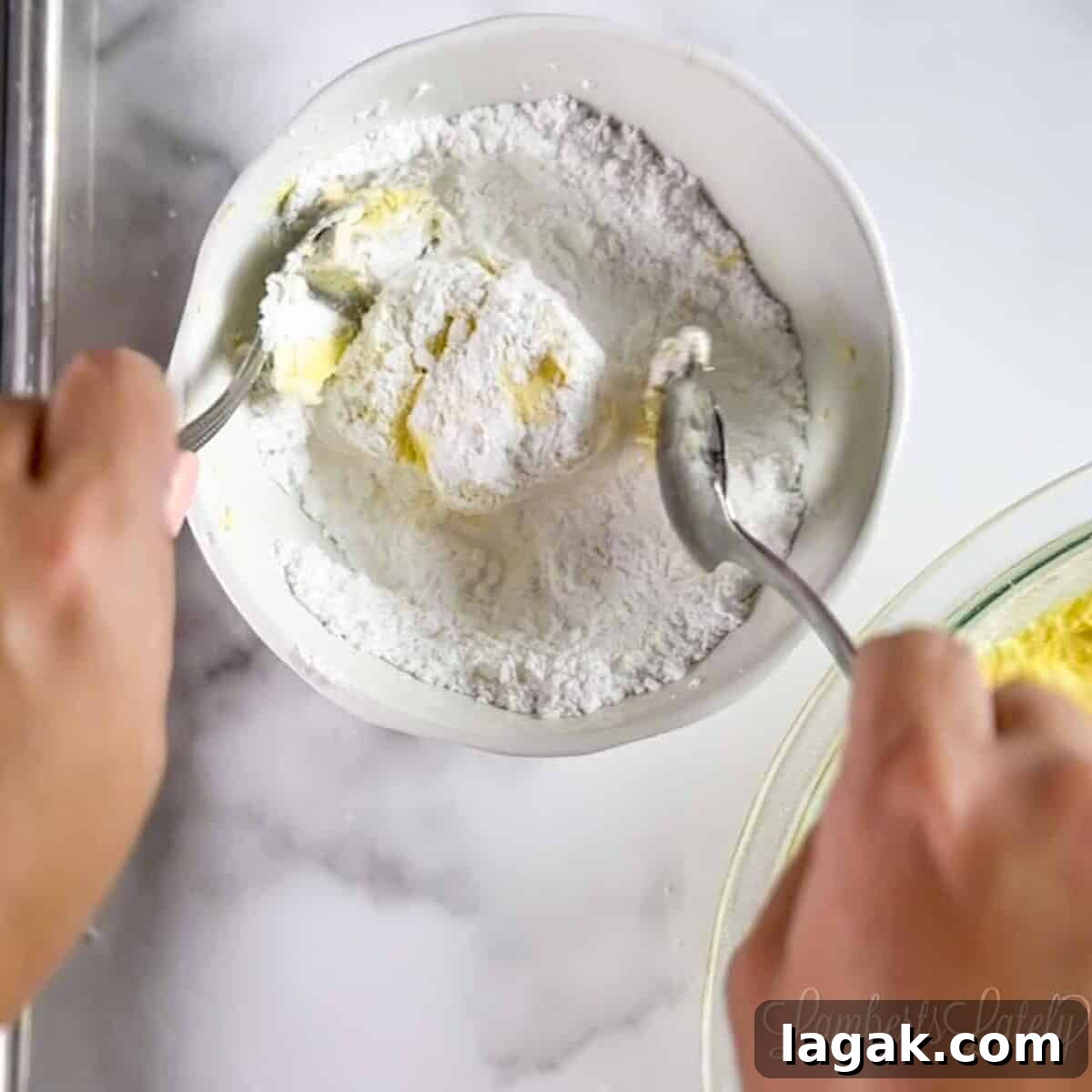 Cake Mix Cookies with Cool Whip: Soft, Fluffy No-Fuss Recipe 5 rolling a ball of cookie dough in a bowl of powdered sugar.