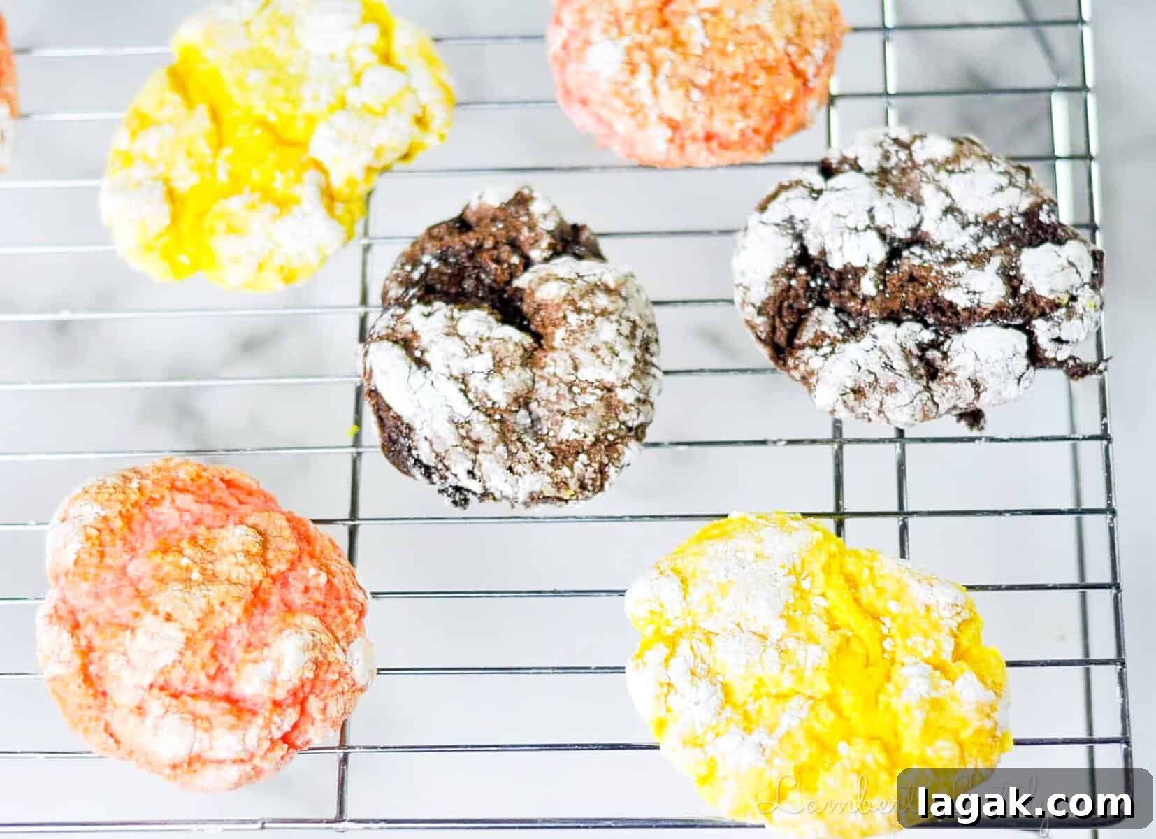 Cake Mix Cookies with Cool Whip: Soft, Fluffy No-Fuss Recipe 7 lemon, chocolate, and strawberry cake mix cool whip cookies on a baking rack.