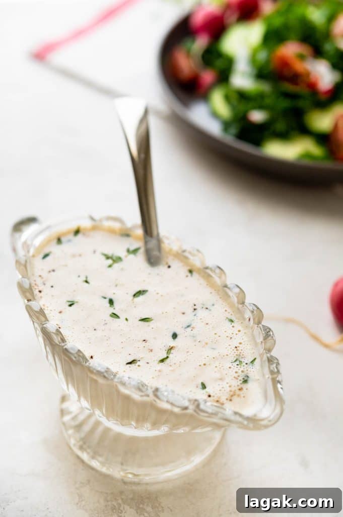 Creamy Garlic Dressing Recipe for Salads and Marinades 5 A serving dish of garlic dressing with a spoon.
