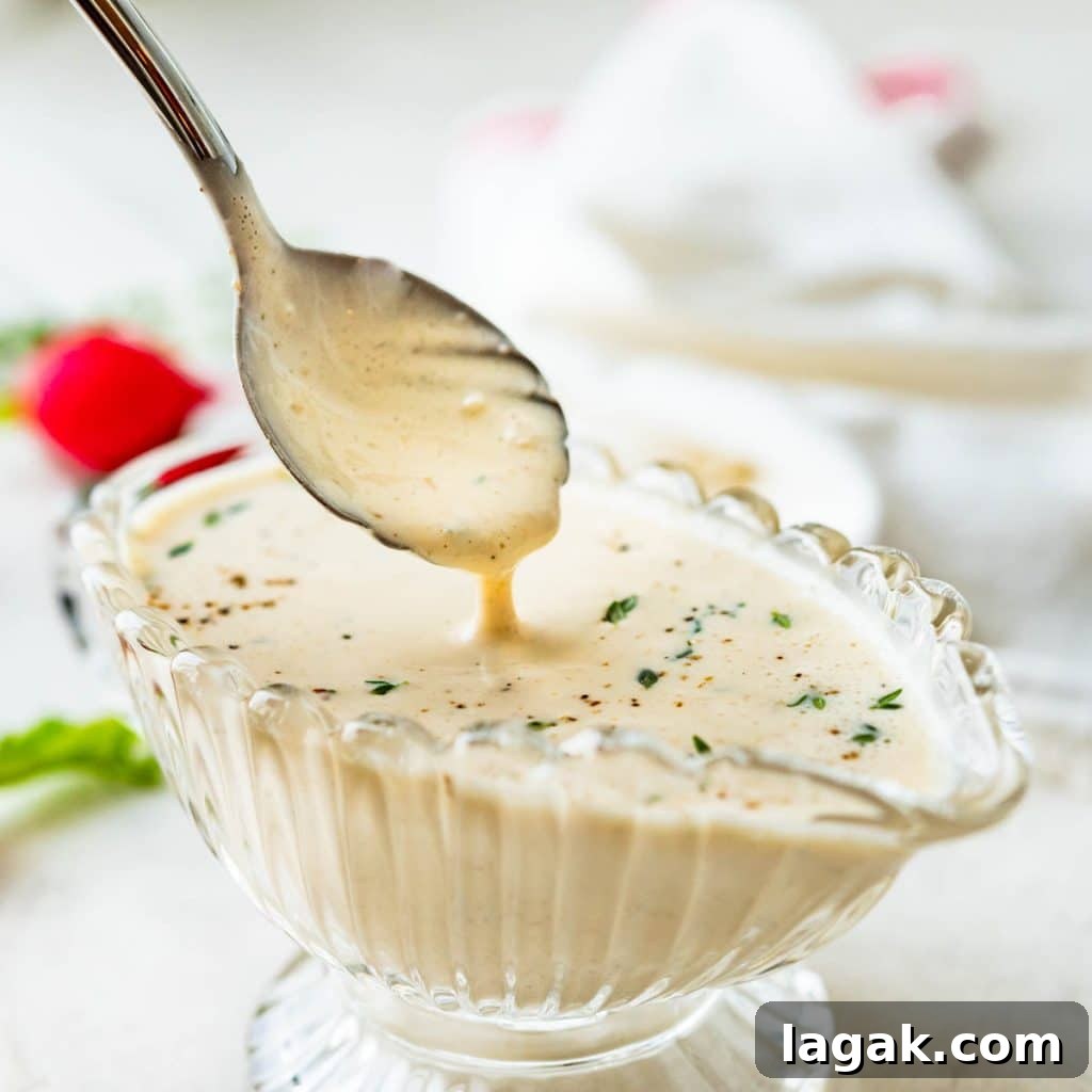 Creamy Garlic Dressing Recipe for Salads and Marinades 6 spooning up the creamy garlic dressing.