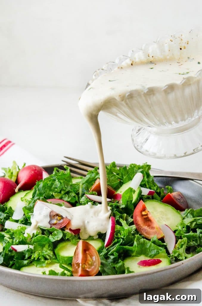 Creamy Garlic Dressing Recipe for Salads and Marinades 7 pouring the garlic dressing over the salad.