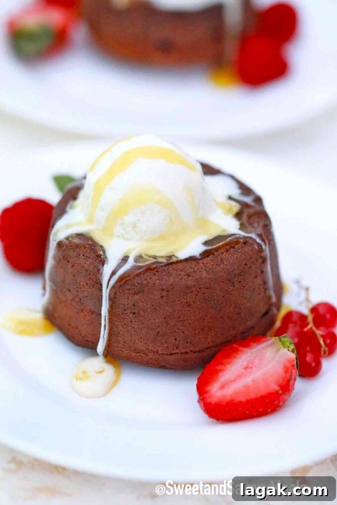 Air Fryer Molten Chocolate Cakes: 4 Delicious Variations 7 chocolate lava cake topped with ice cream and served with strawberries on the side
