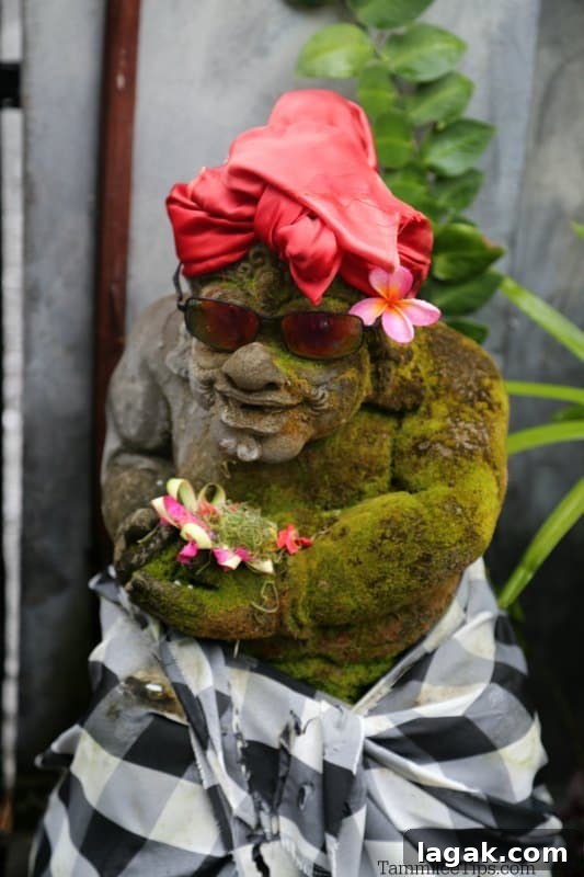 Statue with sunglasses, a red scarf and flowers 