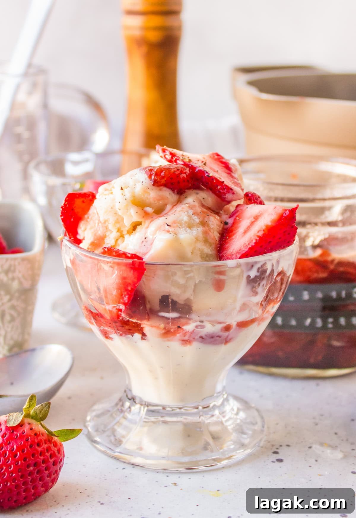 dish of ice cream with balsamic strawberry sauce on top