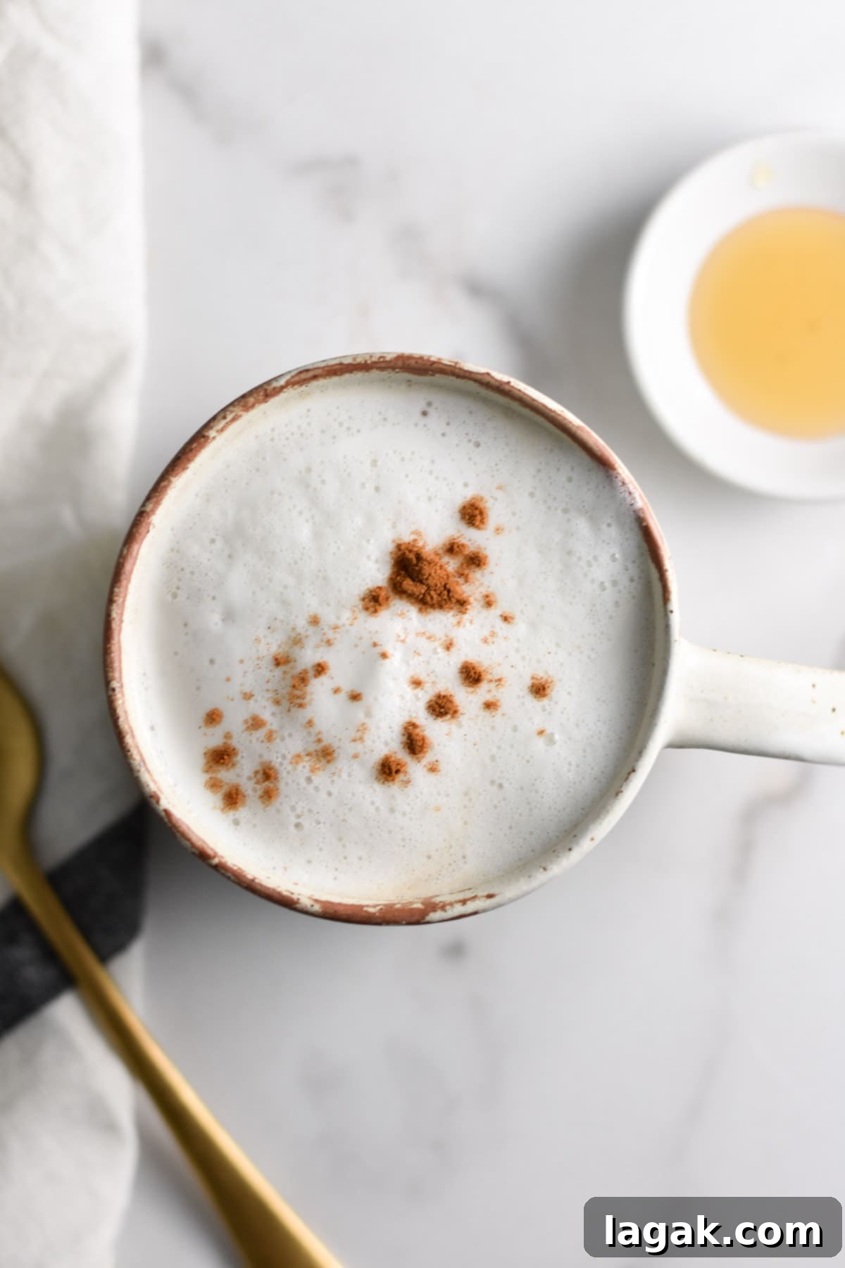 Tea latte with a spoon and honey.