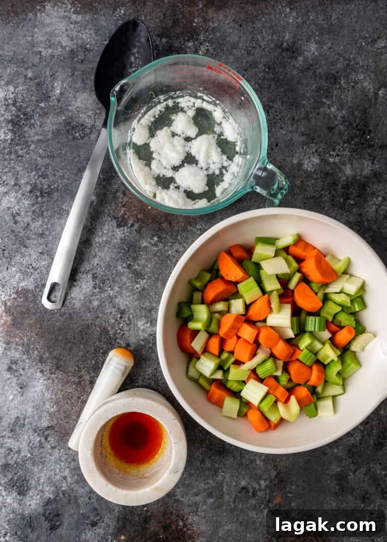 overhead process shot: skim foam off simmering chicken & chopped vegetables in a bowl