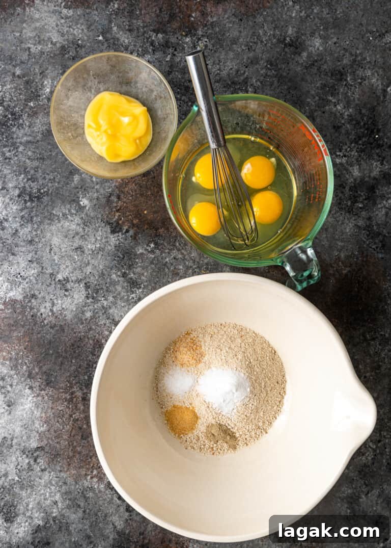 eggs in measuring cup and seasonings to make matzo ball soup in bigger mixture bowl