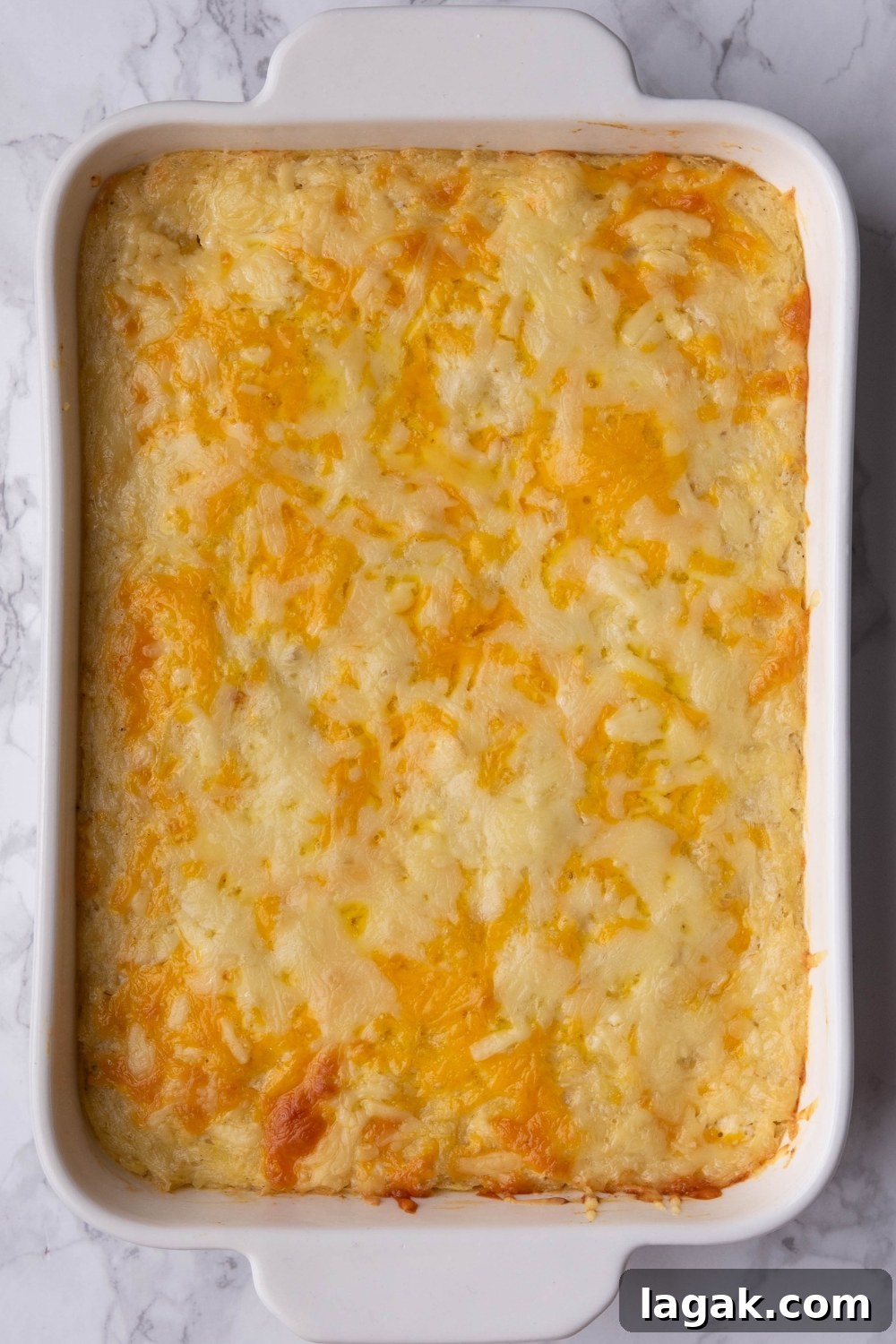 A casserole dish with cooked hash brown casserole in it.