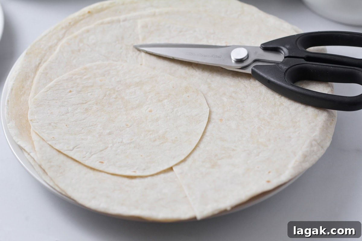 Cutting tortillas into smaller circles.
