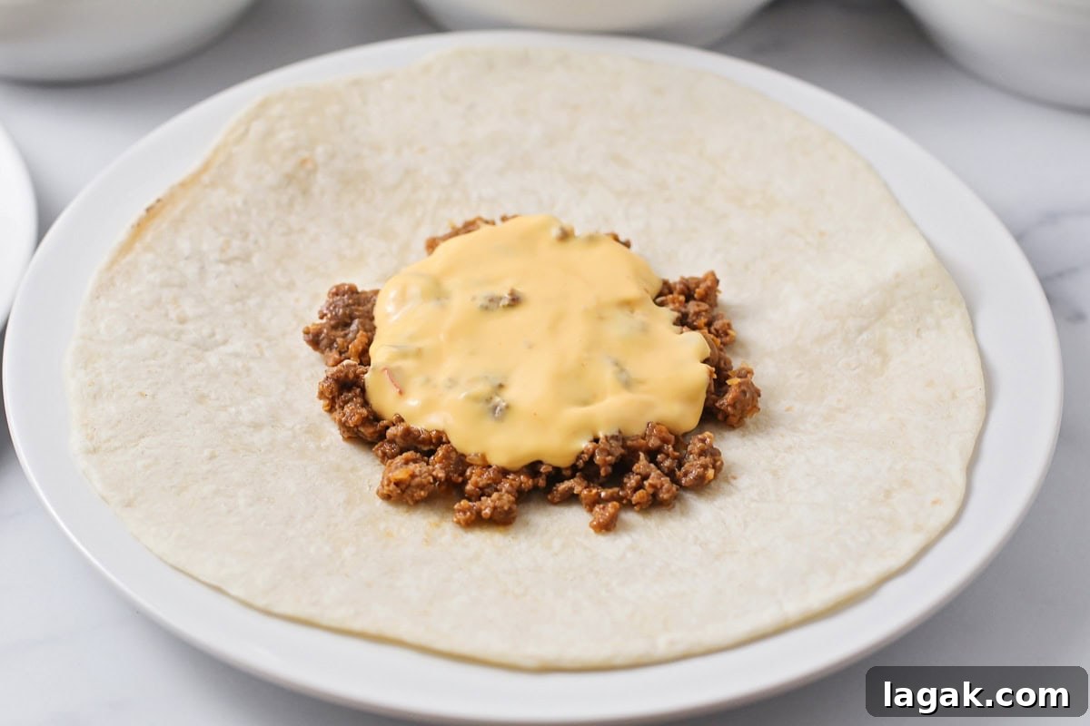Hamburger and cheese on tortillas.