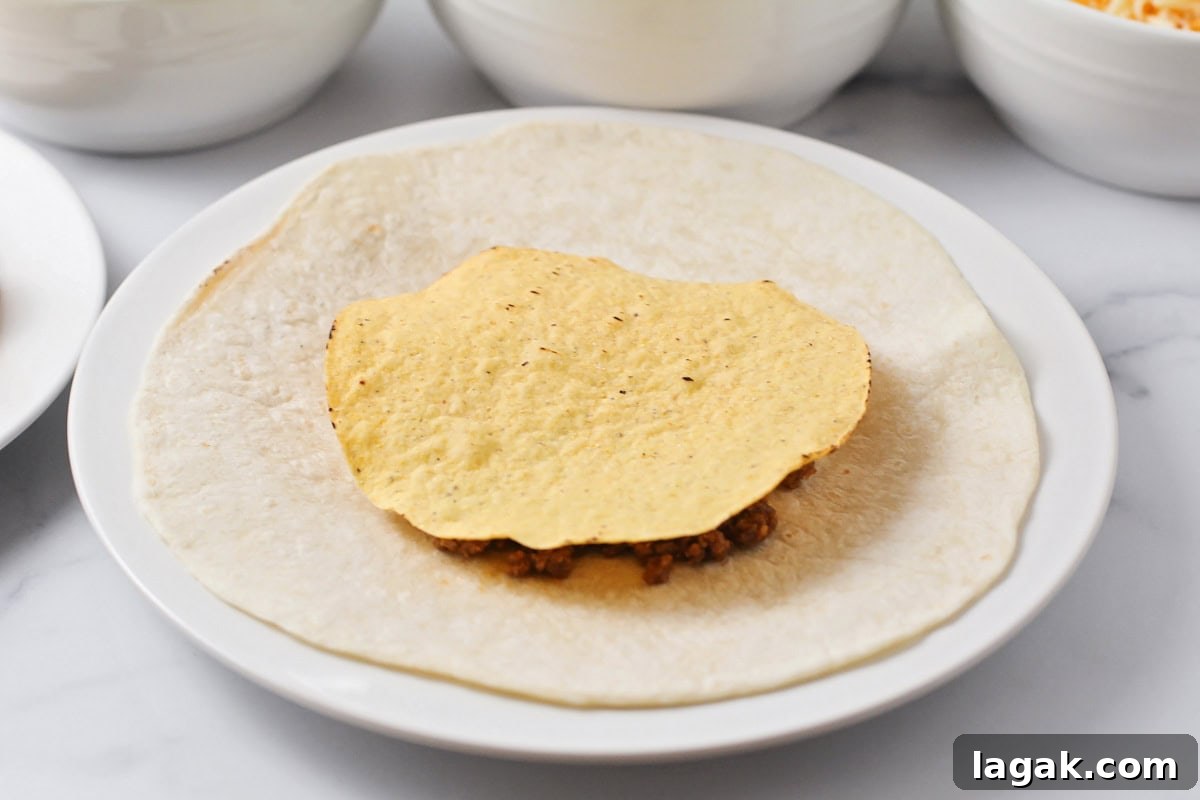 Tostada shell layered on ingredients for tortillas.
