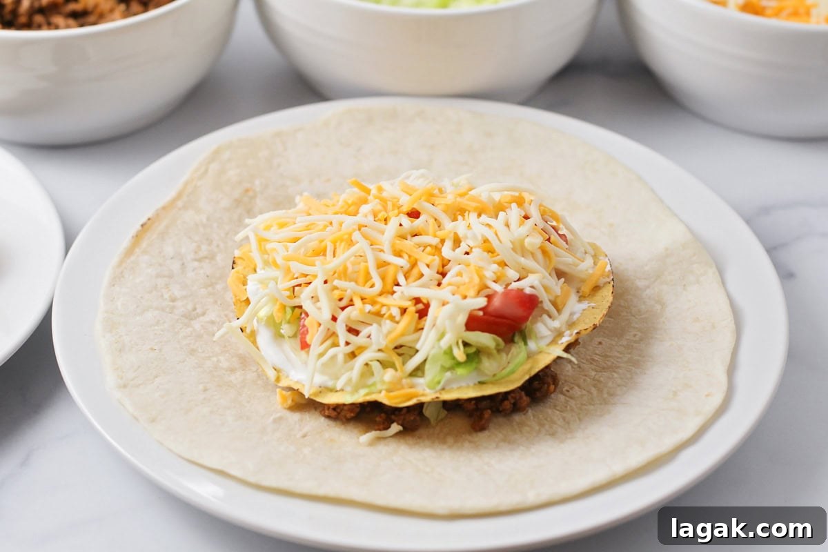Toppings on tortilla for crunchwrap supreme.