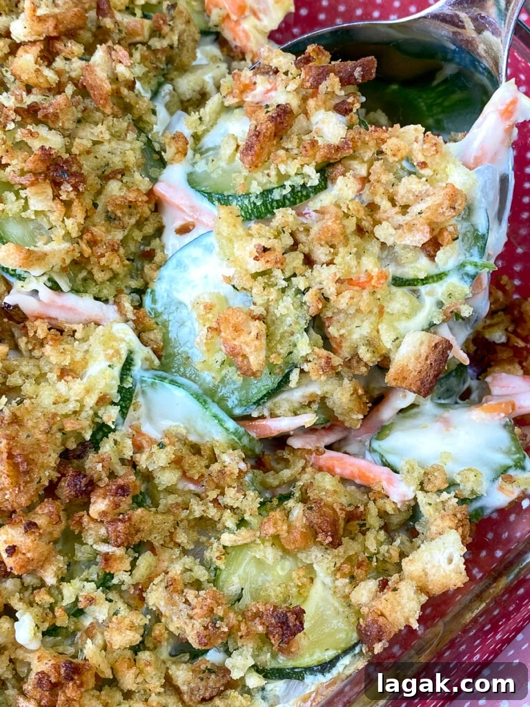 Spoonful of easy stuffing zucchini casserole on a red napkin