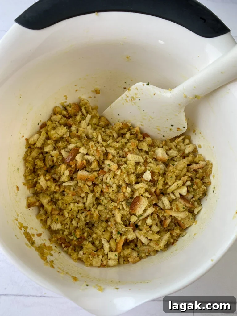 Chicken stuffing mix with melted butter stirred in in a mixing bowl