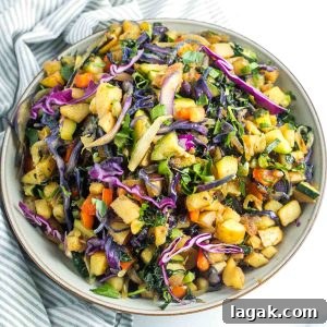 Chopped potatoes mixed in with colorful veggies like kale, red pepper, purple cabbage and zucchini for a colorful veggie hash.