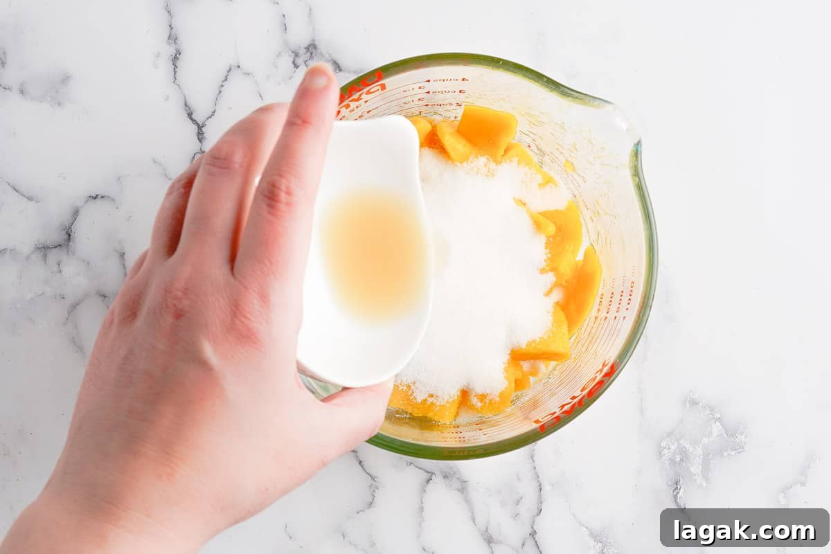 lemon juice being poured into cup with popsicle ingredients
