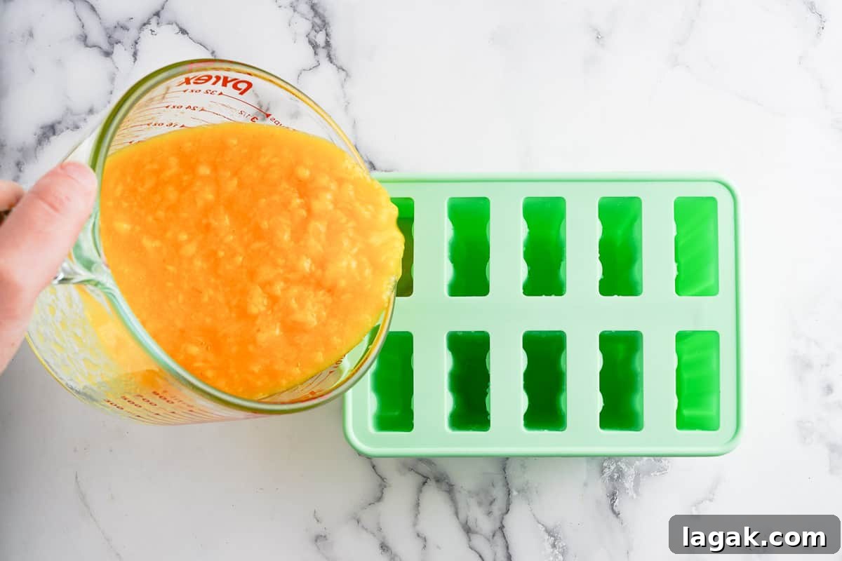 popsicle mix being poured into mold