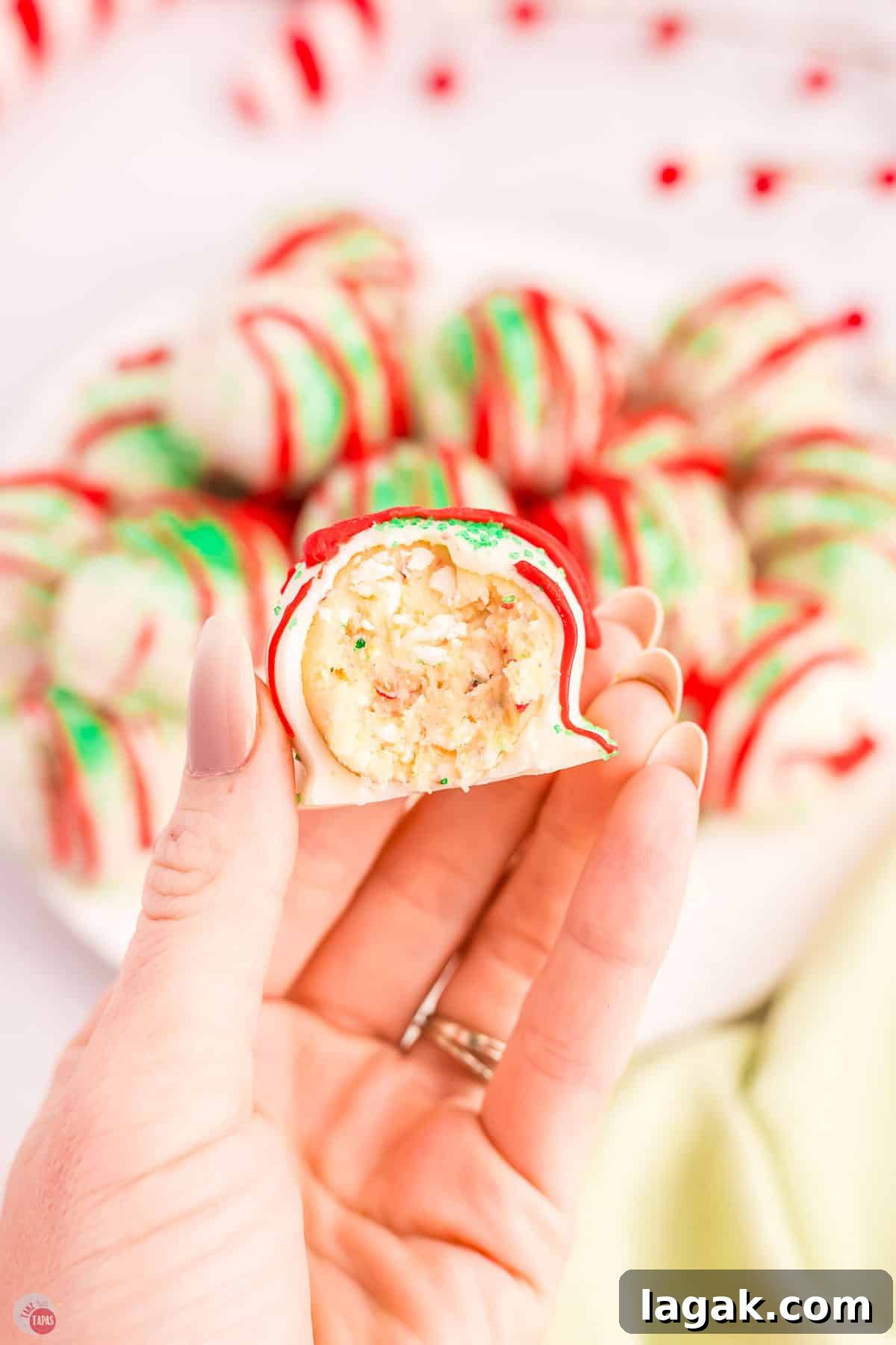 hand holding a cake ball with a bite missing