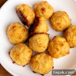 light tan baked chicken meatballs with dark brown spots in white bowl