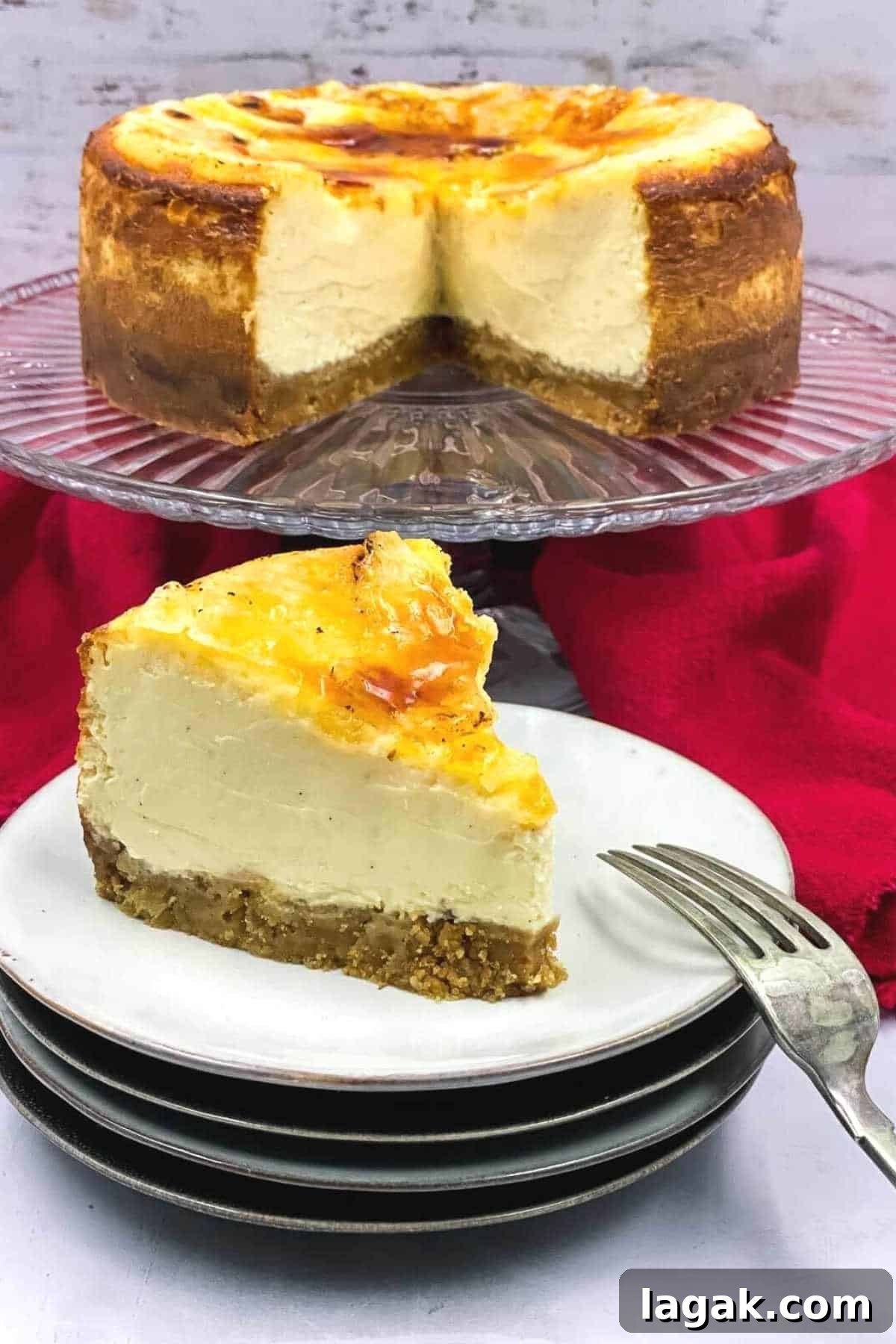Creme Brulee Cheesecake slice placed on a stack of white plates