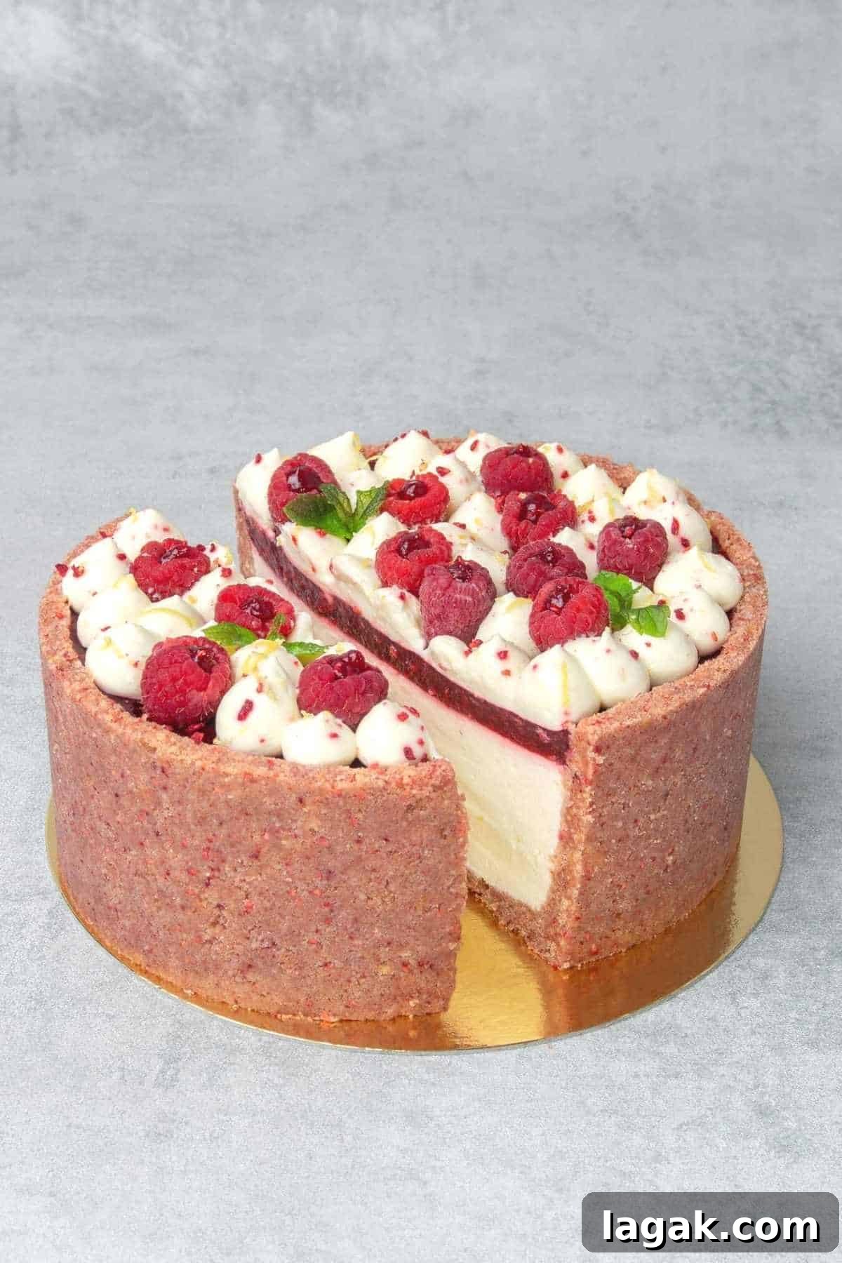 no bake raspberry cheesecake sliced in the middle to reveal the layers from inside