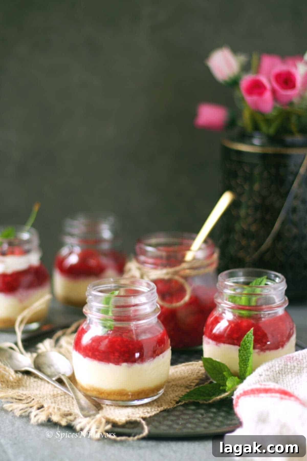 5 cute little jars filled with new york style cheesecake and topped with strawberry compote