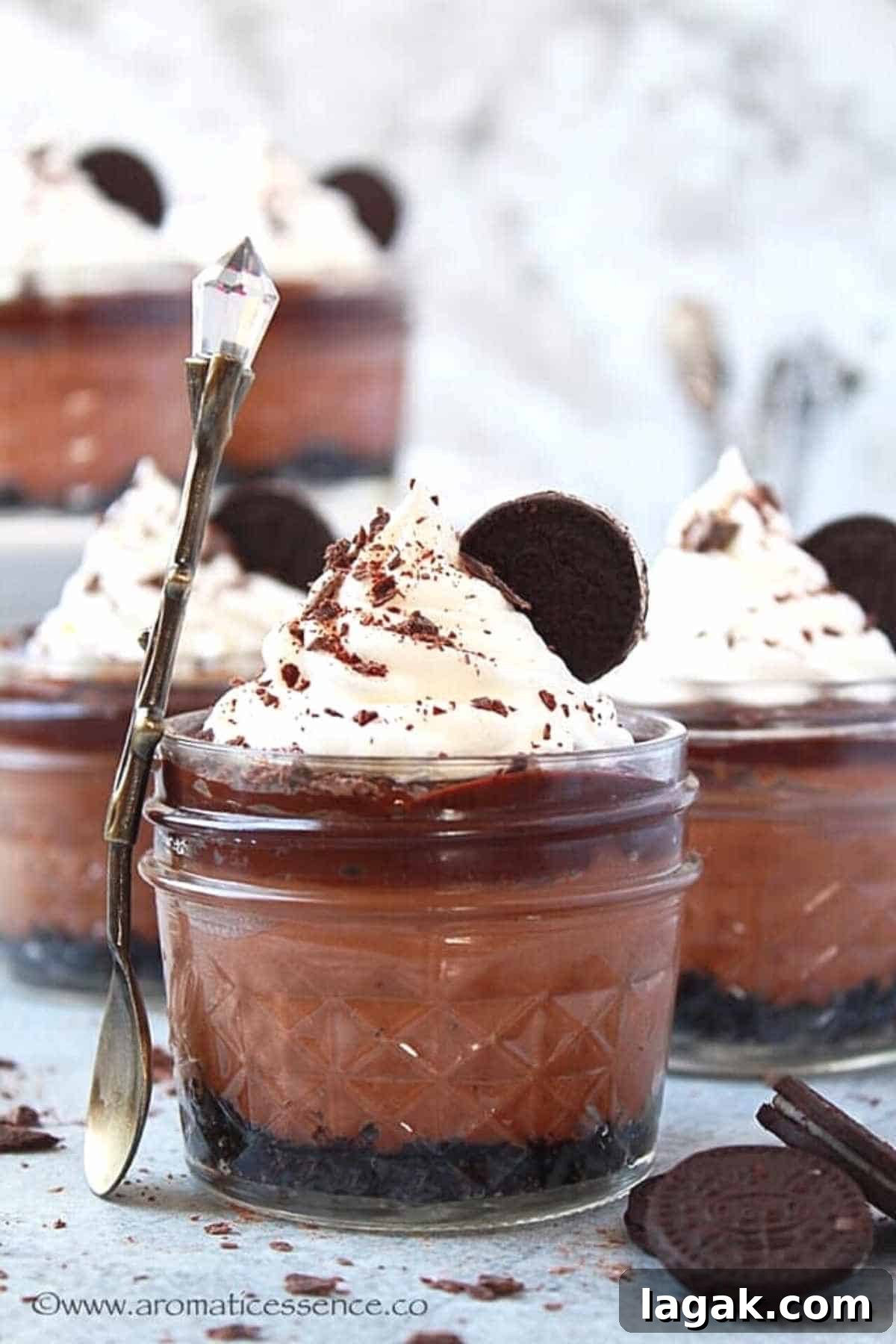cute mason jars filled with chocolate cheesecake and topped with whipped cream