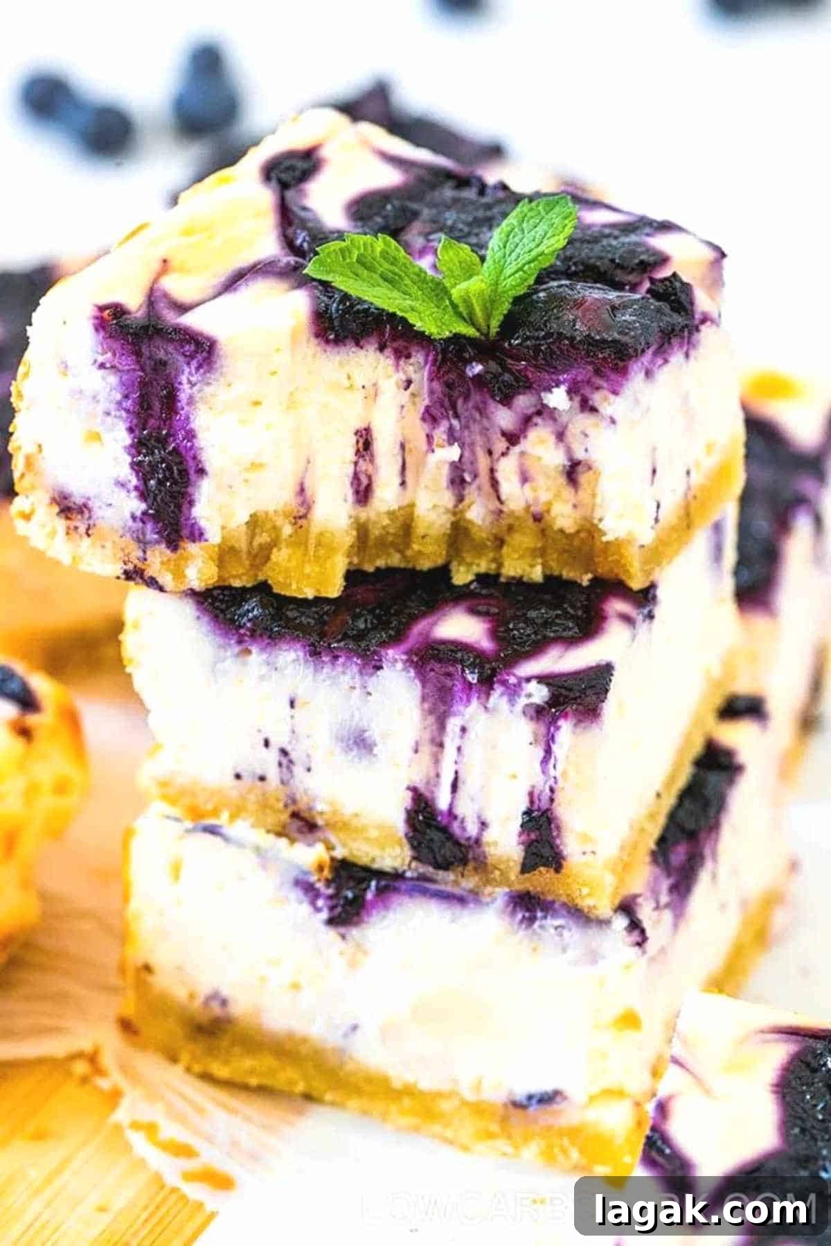 keto blueberry cheesecake bars stacked on top of each other